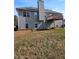 Exterior of home featuring back deck, grey siding, and a chimney at 7603 Autumn Breeze, Douglasville, GA 30134