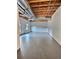 Unfinished basement with exposed beams, concrete floor, and a window at 7603 Autumn Breeze, Douglasville, GA 30134