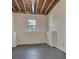 Unfinished basement room with concrete flooring and a single window at 7603 Autumn Breeze, Douglasville, GA 30134