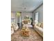 Cozy living room featuring neutral furniture, a patterned rug, and a dining area at 7603 Autumn Breeze, Douglasville, GA 30134