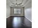 Well-lit main bedroom with dark hardwood floors and a view from the window at 7603 Autumn Breeze, Douglasville, GA 30134