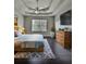 Serene main bedroom with tray ceilings, a ceiling fan, and coordinated decor at 7603 Autumn Breeze, Douglasville, GA 30134