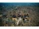 Extensive aerial view of the neighborhood showing multiple homes amidst a dense forest at 9625 River Lake Dr, Roswell, GA 30075