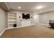 Finished basement featuring carpeted floors, media setup with built-in shelving and cabinets at 9625 River Lake Dr, Roswell, GA 30075