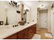 Elegant bathroom with double sinks, wood cabinets, and neutral tile at 9625 River Lake Dr, Roswell, GA 30075