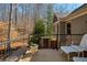 Back deck with wooded view with seating and flower pot at 9625 River Lake Dr, Roswell, GA 30075