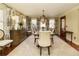 Elegant dining room featuring a wooden table, chandelier, and patterned curtains at 9625 River Lake Dr, Roswell, GA 30075