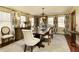 Elegant dining room featuring a wooden table, chandelier, and patterned curtains at 9625 River Lake Dr, Roswell, GA 30075