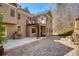 Exterior of home with stone patio and deck with grill at 9625 River Lake Dr, Roswell, GA 30075