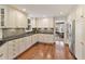 Bright kitchen with plenty of cabinet space, tiled backsplash, stainless steel appliances, and hardwood floors at 9625 River Lake Dr, Roswell, GA 30075