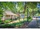 Charming restaurant exterior featuring a covered porch, manicured landscaping, and a welcoming atmosphere at 9625 River Lake Dr, Roswell, GA 30075