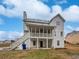 Backyard view of the house with a screened porch, staircase, and deck at 1835 Big Haynes Ct, Grayson, GA 30017