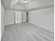 Large bedroom with tray ceilings, soft carpet, neutral walls, and interior doors at 1835 Big Haynes Ct, Grayson, GA 30017