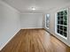 A bright, spacious bedroom featuring hardwood floors and natural light from dual windows at 1835 Big Haynes Ct, Grayson, GA 30017