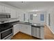 Well-lit kitchen boasts sleek countertops, modern appliances, and an adjacent dining area with a window view at 1835 Big Haynes Ct, Grayson, GA 30017
