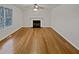 Hardwood flooring and a cozy fireplace highlight this spacious living room with natural light at 1835 Big Haynes Ct, Grayson, GA 30017