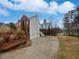 Spacious driveway leading to a two-car garage and an expansive lawn near a tranquil waterfront at 1835 Big Haynes Ct, Grayson, GA 30017
