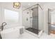 Modern bathroom features a standalone tub, glass enclosed shower with decorative tile, and stylish light fixture at 624 3Rd Ave, Decatur, GA 30030