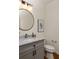 Charming powder room with marble countertop, grey vanity, and modern fixtures at 624 3Rd Ave, Decatur, GA 30030