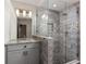 Stylish bathroom featuring a glass-enclosed shower and gray vanity with granite countertops at 624 3Rd Ave, Decatur, GA 30030