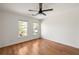 A well-lit bedroom with hardwood floors, a ceiling fan, and views from two windows at 624 3Rd Ave, Decatur, GA 30030