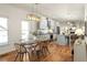 Elegant dining room with modern lighting, hardwood floors, and adjacent kitchen island at 624 3Rd Ave, Decatur, GA 30030