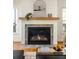 Modern fireplace design with a stone surround, wooden mantle, and arched mirror above at 624 3Rd Ave, Decatur, GA 30030