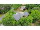 Aerial view of a gray roof house with a long driveway, surrounded by mature trees and greenery at 716 Counsel Ne Dr, Marietta, GA 30068