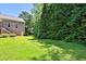 Manicured lawn with green trees surrounding a large stone house at 716 Counsel Ne Dr, Marietta, GA 30068