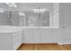 Bathroom featuring all white cabinetry, a large countertop, and an expansive vanity mirror at 716 Counsel Ne Dr, Marietta, GA 30068