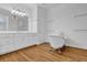 Bathroom showcasing a clawfoot bathtub, white cabinetry, and a large vanity mirror at 716 Counsel Ne Dr, Marietta, GA 30068