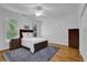 Bright bedroom featuring hardwood floors, a ceiling fan, and great natural light at 716 Counsel Ne Dr, Marietta, GA 30068