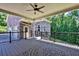 Covered outdoor deck featuring a ceiling fan, stone wall, and iron railing at 716 Counsel Ne Dr, Marietta, GA 30068