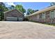 View of a stone house with a spacious driveway and an attached two-car garage at 716 Counsel Ne Dr, Marietta, GA 30068