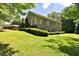 View of the side of a house featuring several windows, and a well-manicured lawn at 716 Counsel Ne Dr, Marietta, GA 30068