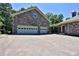 Stone facade home with two-car garage and large driveway, providing ample parking and curb appeal at 716 Counsel Ne Dr, Marietta, GA 30068