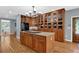 Gourmet kitchen featuring a central island, hardwood floors, built-in china cabinets, and modern appliances at 716 Counsel Ne Dr, Marietta, GA 30068