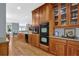 Stylish kitchen with a double oven, hardwood floors, and wood cabinetry, perfect for culinary enthusiasts at 716 Counsel Ne Dr, Marietta, GA 30068