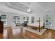 Bright main bedroom featuring hardwood floors, trey ceiling, and multiple windows with outside views at 716 Counsel Ne Dr, Marietta, GA 30068