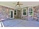 Relaxing covered outdoor patio with plank flooring and stone walls at 716 Counsel Ne Dr, Marietta, GA 30068