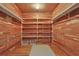 Walk-in closet featuring cedar walls, hardwood floors, and built in shelves at 716 Counsel Ne Dr, Marietta, GA 30068