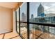 A cityscape through a large window, showcasing the condo's location and downtown skyline at 1280 W Peachtree St Nw # 3208, Atlanta, GA 30309