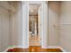 Walk-in closet leading to a bathroom featuring white trim and wire shelving at 1280 W Peachtree St Nw # 3208, Atlanta, GA 30309