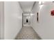 Hallway with neutral carpet, white walls, and visible fire safety equipment at 1280 W Peachtree St Nw # 3208, Atlanta, GA 30309