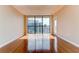 Sunlit, vacant living room with hardwood floors and large windows offering a glimpse of the cityscape at 1280 W Peachtree St Nw # 3208, Atlanta, GA 30309