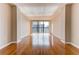 Bright, empty living room featuring hardwood floors, light-colored walls, and a window offering city views at 1280 W Peachtree St Nw # 3208, Atlanta, GA 30309