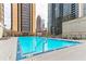 Inviting outdoor pool with city views, lounge chairs, and clear blue water, surrounded by high rises at 1280 W Peachtree St Nw # 3208, Atlanta, GA 30309