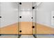 Indoor racquetball court with glass doors and wooden floor at 1280 W Peachtree St Nw # 3208, Atlanta, GA 30309