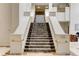 Elegant staircase with marble accents and gold railings, leading to upper floors at 1280 W Peachtree St Nw # 3208, Atlanta, GA 30309