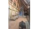 Spacious attic with exposed wooden beams, ladder and visible insulation at 3311 Lindenridge Dr, Buford, GA 30519